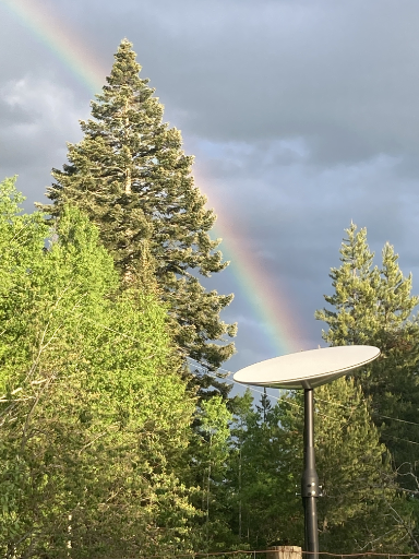 Rainbow with a Starlink dish at the end